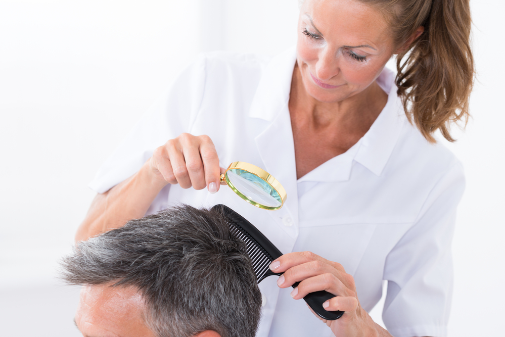 Dermatologist Looking At Patient's Hair